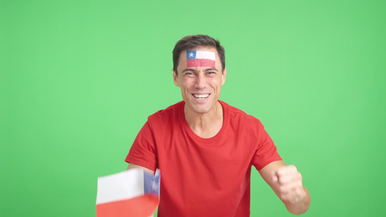 Man cheering for Chile screaming and waving a national flag