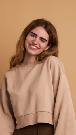happy young woman smiling at camera standing. vertical footage