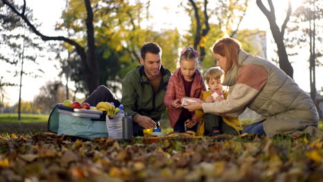 family enjoying a picnic in the park on a beautiful autumn day