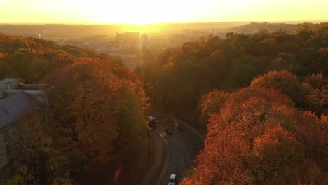 Drone-aerial-view-of-Kaunas-city,-during-autumn-sunset