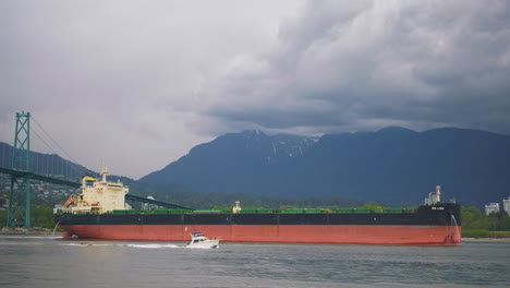 Ocean-liner-container-ship-travels-through-downtown-Vancouver,-British-Columbia,-Canada