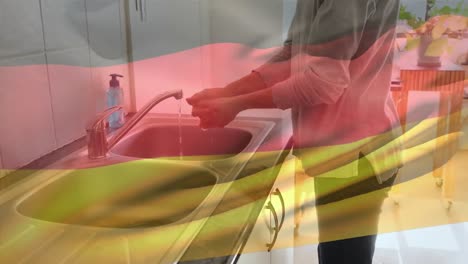 Die-Deutsche-Flagge-Weht-Gegen-Den-Mittelteil-Einer-Frau,-Die-Sich-Im-Waschbecken-Die-Hände-Wäscht