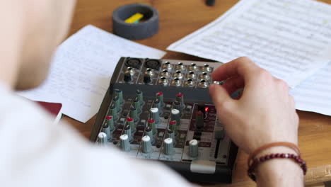 person using a mixing desk