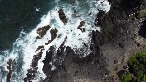 cenital shot of the coast of a black beach in hawaii