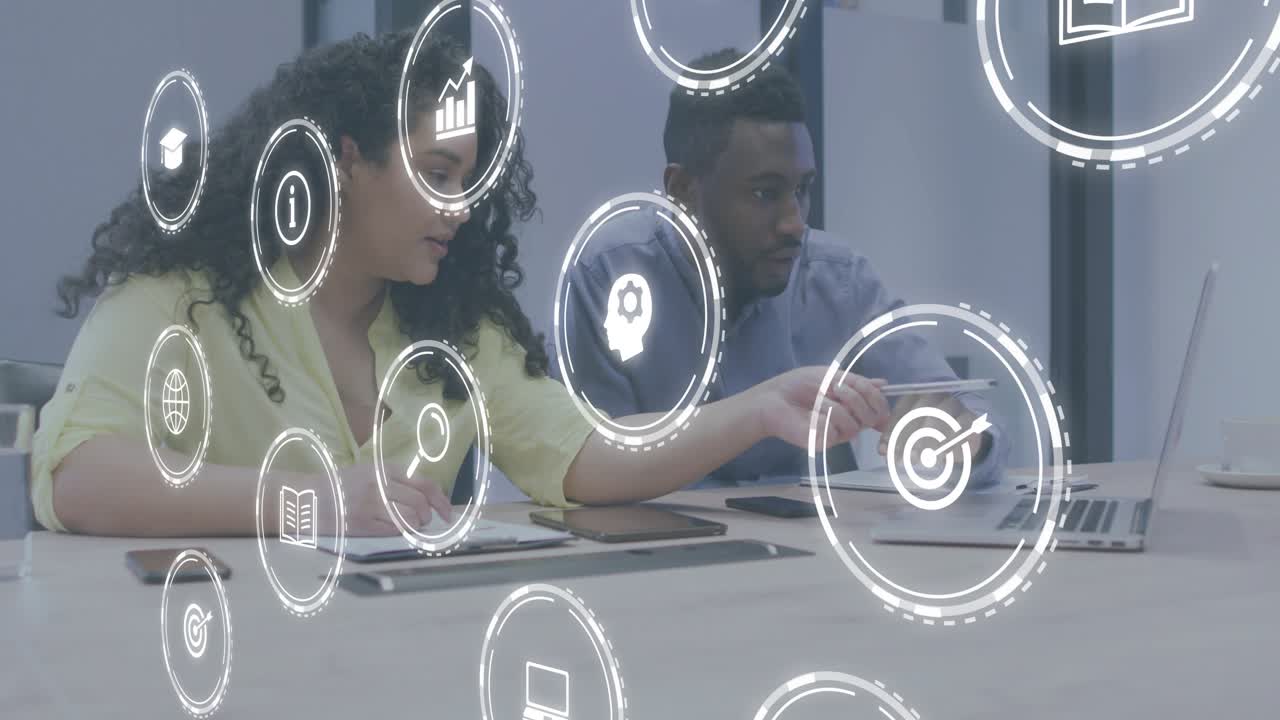 Woman pointing stylus at laptop icons leading man interacting with trackpad for business insights