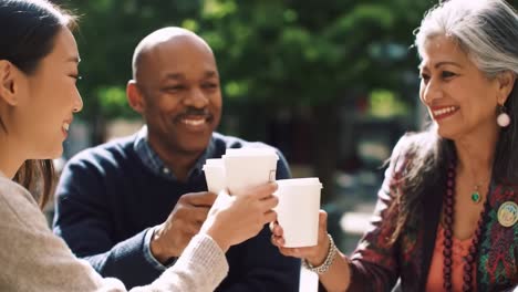 a joyful gathering: friends celebrate over coffee in a warm, outdoor setting, sharing laughter and connection in their favorite cafe