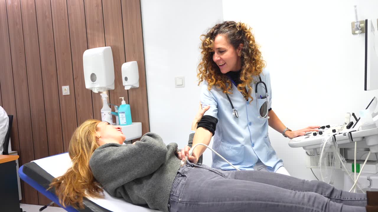 Doctor Performing Ultrasound on Patient