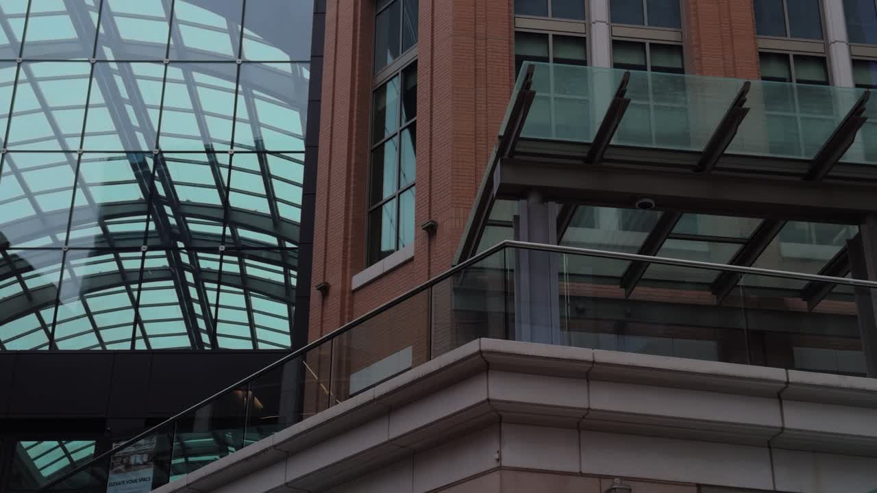 Left to right pan of modern atrium ceiling and brick architecture