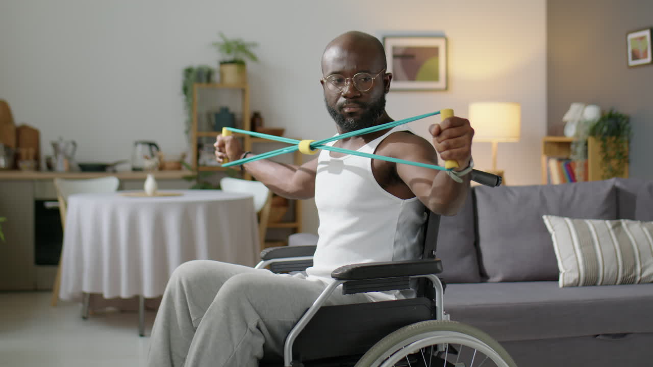 Black Man in Wheelchair Exercising at Home