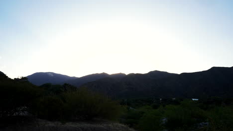 time-lapse of the andes mountain range from dusk until nightfall, capturing the sunset and the sun setting behind the mountains