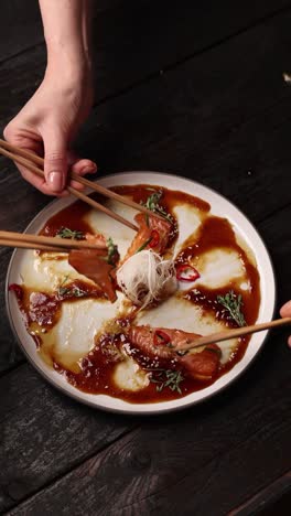 sharing salmon sashimi with chopsticks