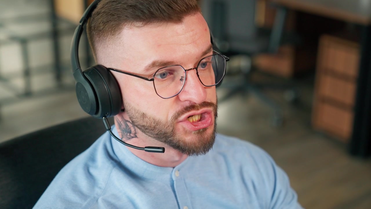 Young Man Wearing Headset and Speaking in Modern Office
