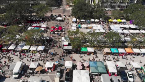 4k aerial drone video of shoppers at farmers market in downtown st