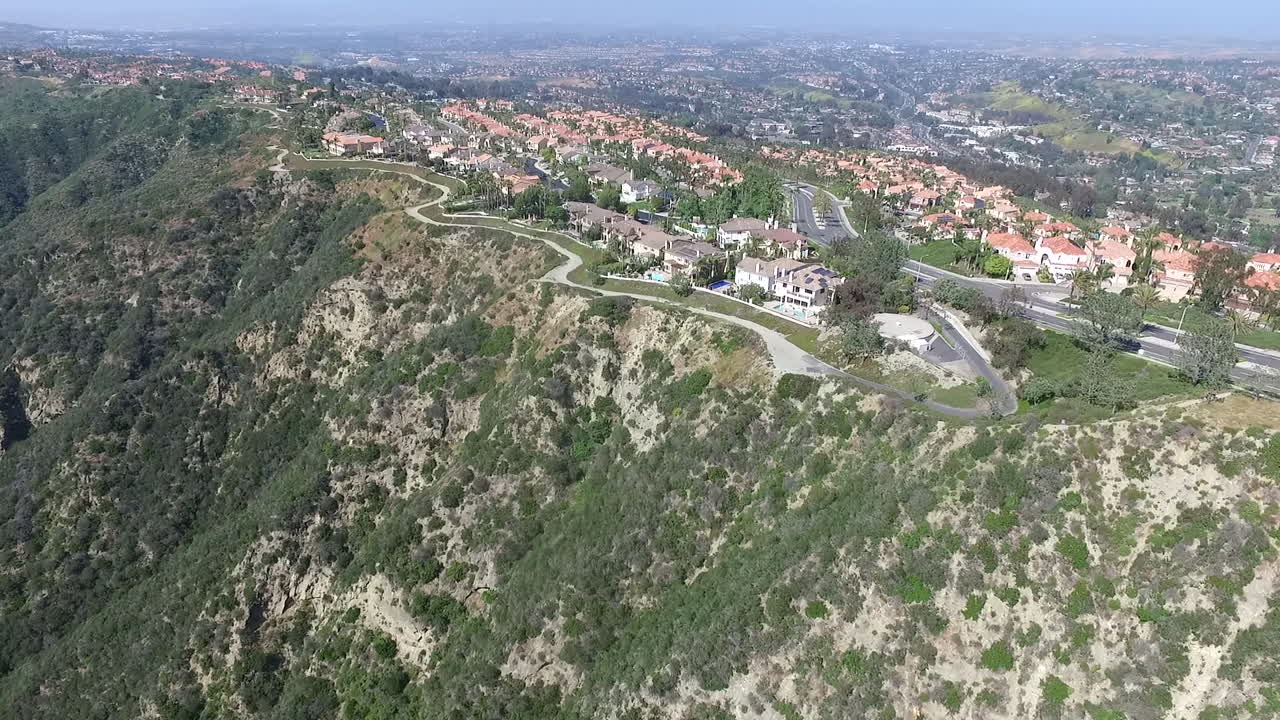 Aerial drone footage of luxury homes over Laguna Niguel, Orange County, California facing Aliso Creek