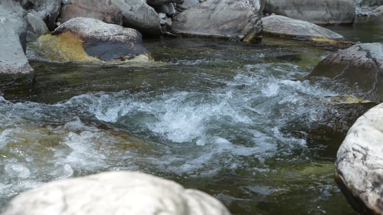 Water is flowing through a mountain torrential river.