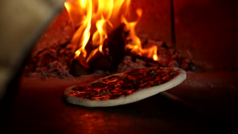 pizza baking in a wood-fired oven