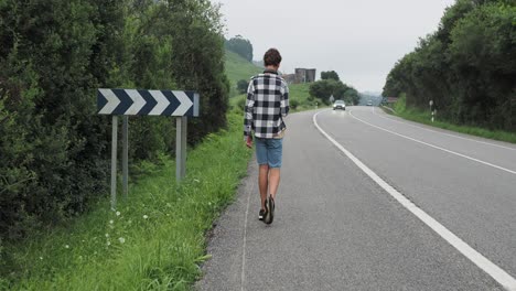 man walking on a country road