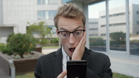 man receiving news on phone, looking shocked and astonished