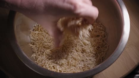 Coating-Chicken-Breast-Fillet-With-Seasoned-Mixture-Of-Ground-Oatmeal-And-Grated-Gouda-Cheese-In-A-Bowl