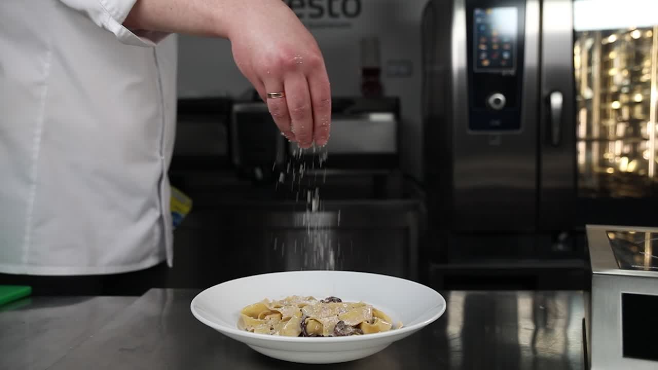 chef preparando pasta de setas con crema