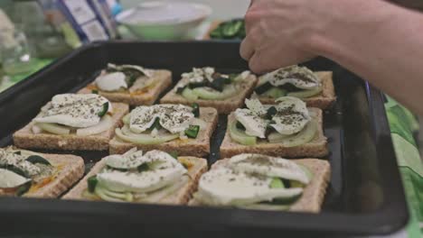 Adding-meat-to-a-baking-tray-full-of-toast