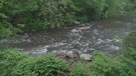 The-Wissahickon-Creek,-high-angle,-flowing-over-rocks-and-stones