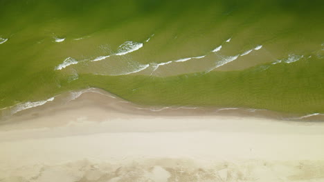 Foamy-waves-washing-the-sandy-beach-of-Baltic-Sea