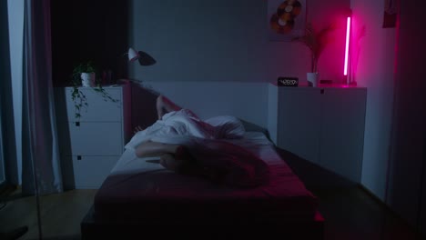 person sleeping in a stylish bedroom at night