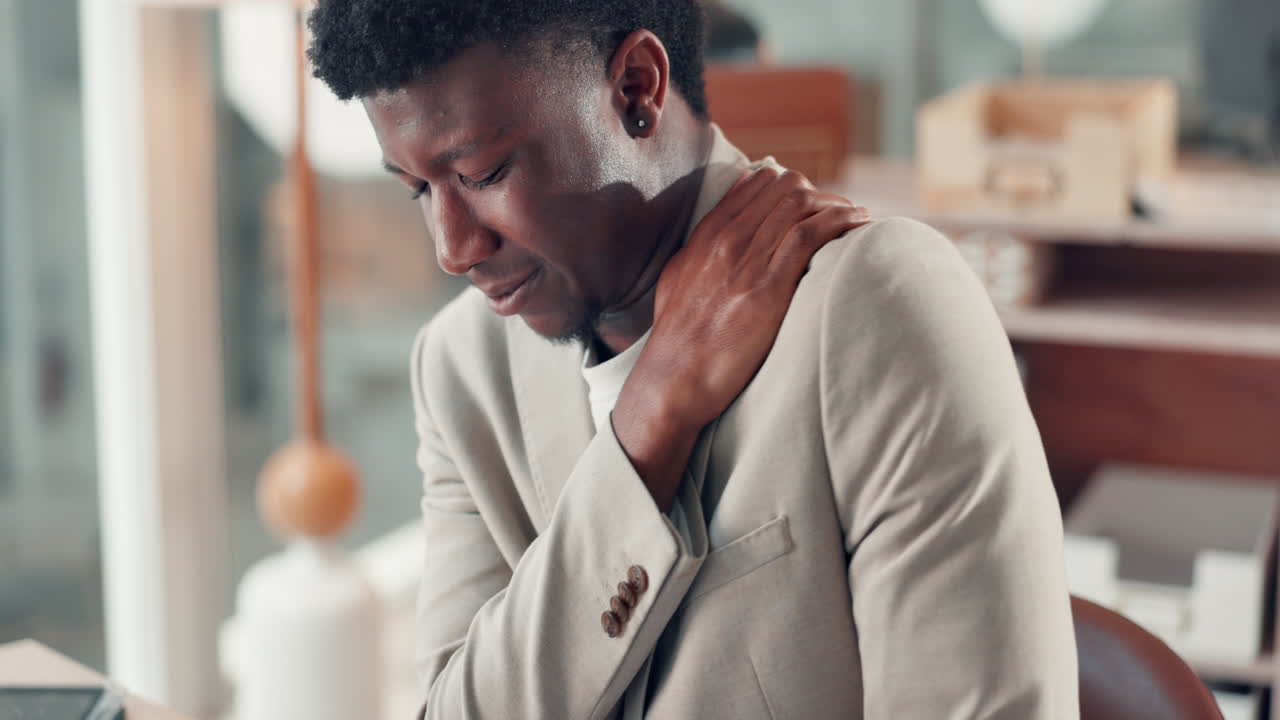 Man with shoulder pain in the office
