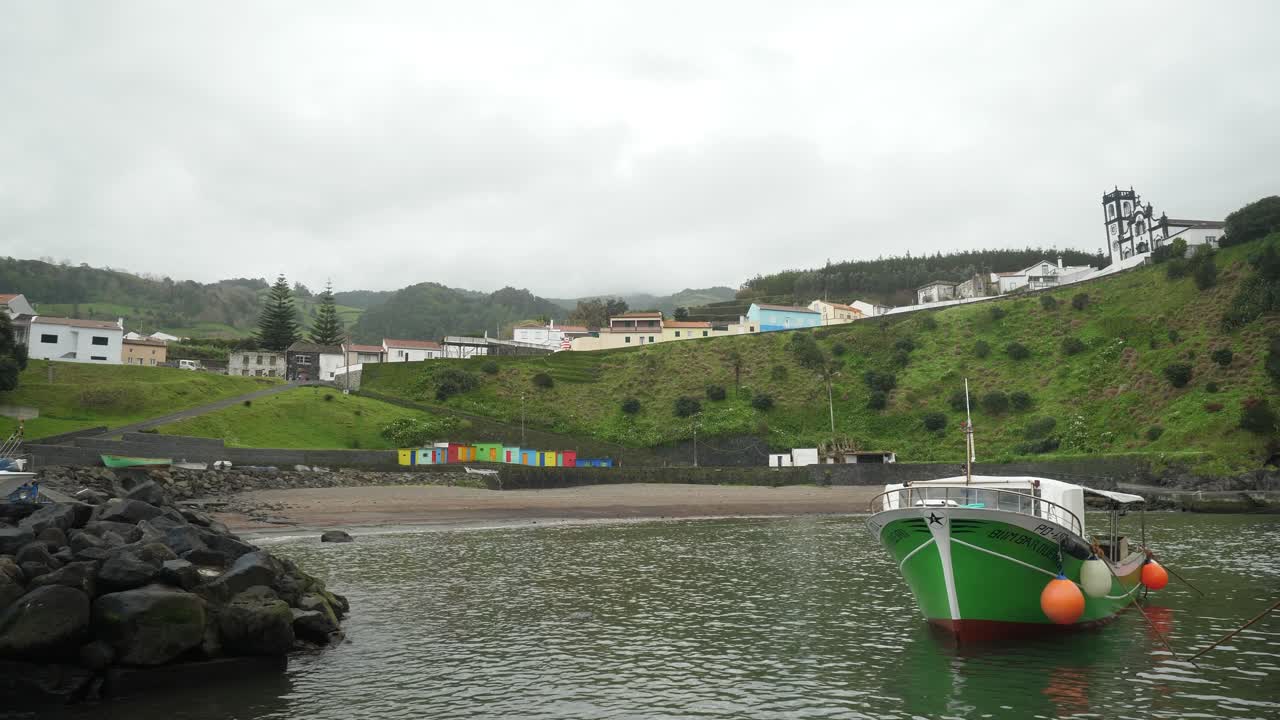 barco verde en el agua - puerto de porto formoso, azores
