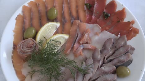 meat and red fish served on a plate