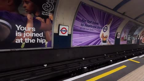 people waiting at a london underground station