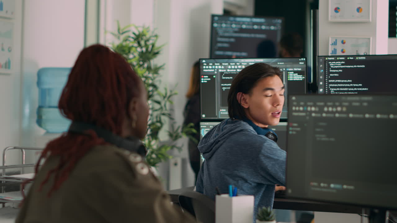 Asian system engineer asking coder for help with html code