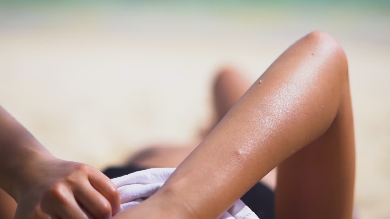 Arm Of Woman Sunbathing At Beach In Cook Islands During Summer. closeup, cropped shot