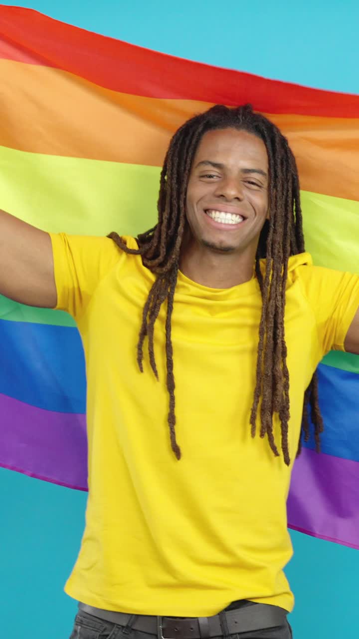Man holding LGBTQ rainbow flag