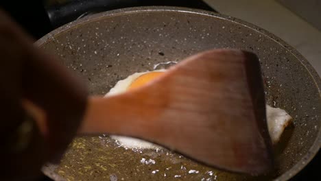 frying an egg in a pan