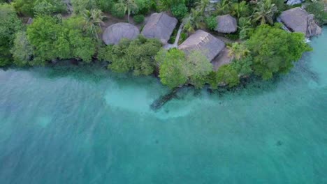 Aerial-dolly-out-revealing-rural-coastal-bungalows-on-tropical-Rosario-islands,-Colombia