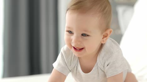 happy baby crawling on the bed