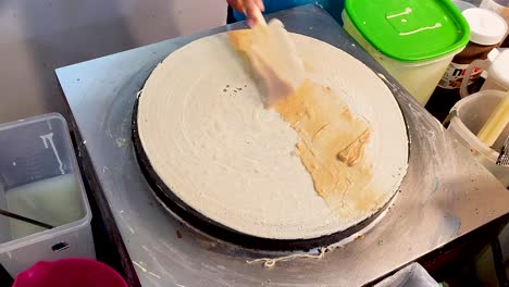 making delicious crepe with sweet toppings, close up view