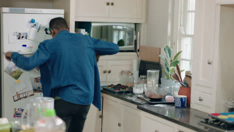 happy-african-american-man-dancing-in-kitchen-having-fun-dance-celebration-enjoying-weekend-at-home