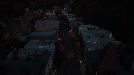 car drives through dark town at night