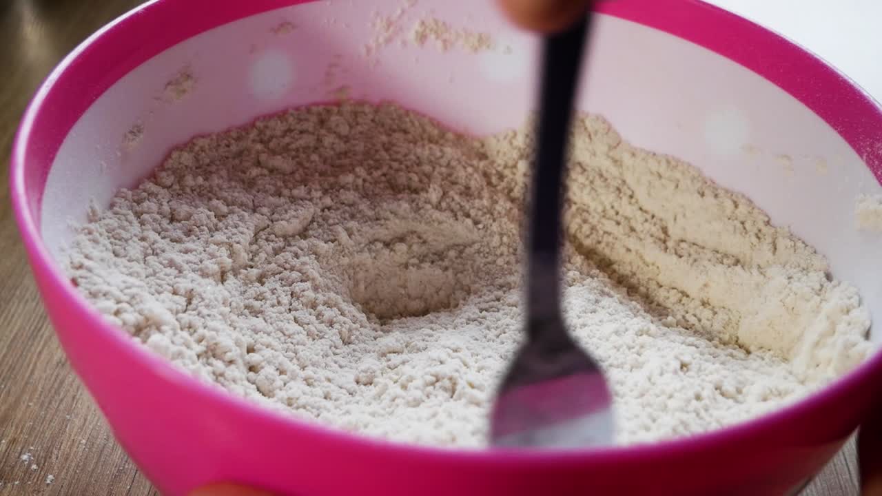 Mixing flour and sugar for pancakes preparation in home kitchen. Amateur cook. Side close up view.