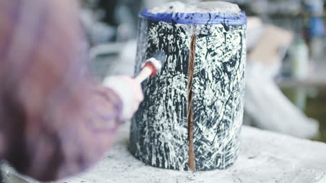 young woman painting tree stump lifestyle background