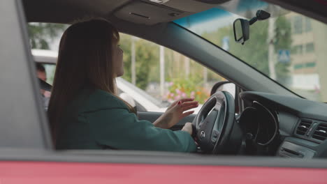 businesswoman turns steering wheel moving in traffic jam