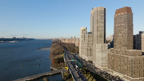 Aerial-view-flying-along-the-coast-of-Hudson-river,-spring-day-in-Upper-West-Side-of-Manhattan,-NY,-USA