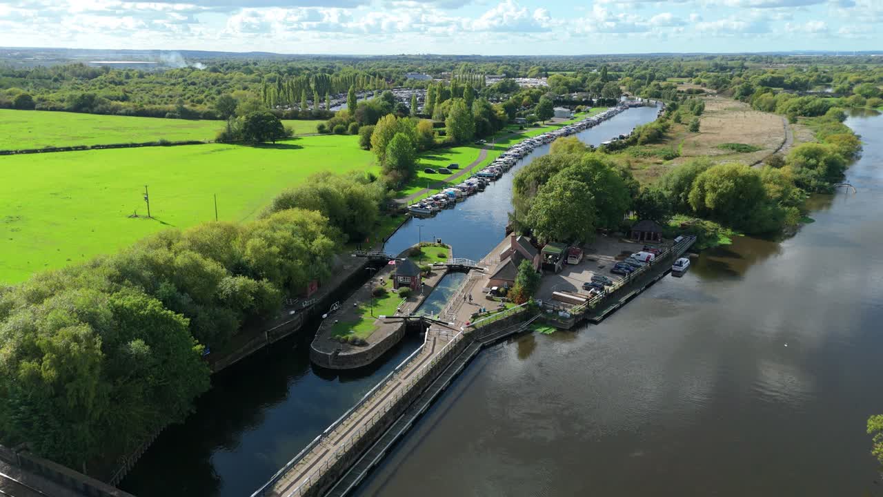Aerial drone shot of canal river lock gates and rolling green landscape near Nottingham, United Kingdom, pleasure cruise narrow boat holidays
