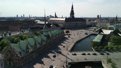 aerial descent of borsen stock exchange and christiansborg palace, copenhagen, denmark