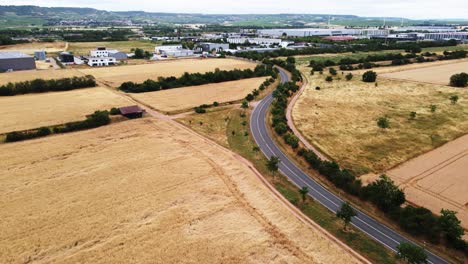 Aerial:-Fly-next-to-a-Street-surrounded-by-endless-corn-fields-in-Germany