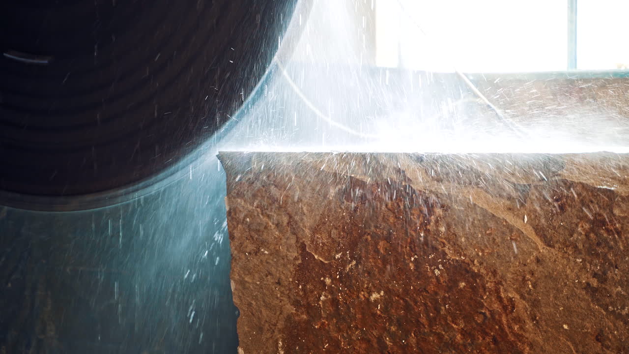 Machine cutting a marble block. Marble sawing machine in a factory from a quarry