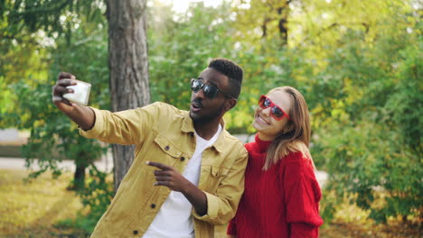 couple taking a selfie in an autumn park